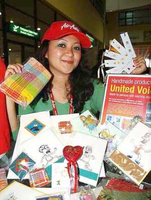 Unique: AirAsia employee Yvonne Lady Diana with UV handmade products at AirAsia's merchandise kiosk at the LCC Terminal, KLIA Sepang.